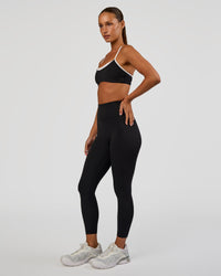 Woman wearing Tempo Sports Bra - Black-White | Model:Brylee | Size:XS