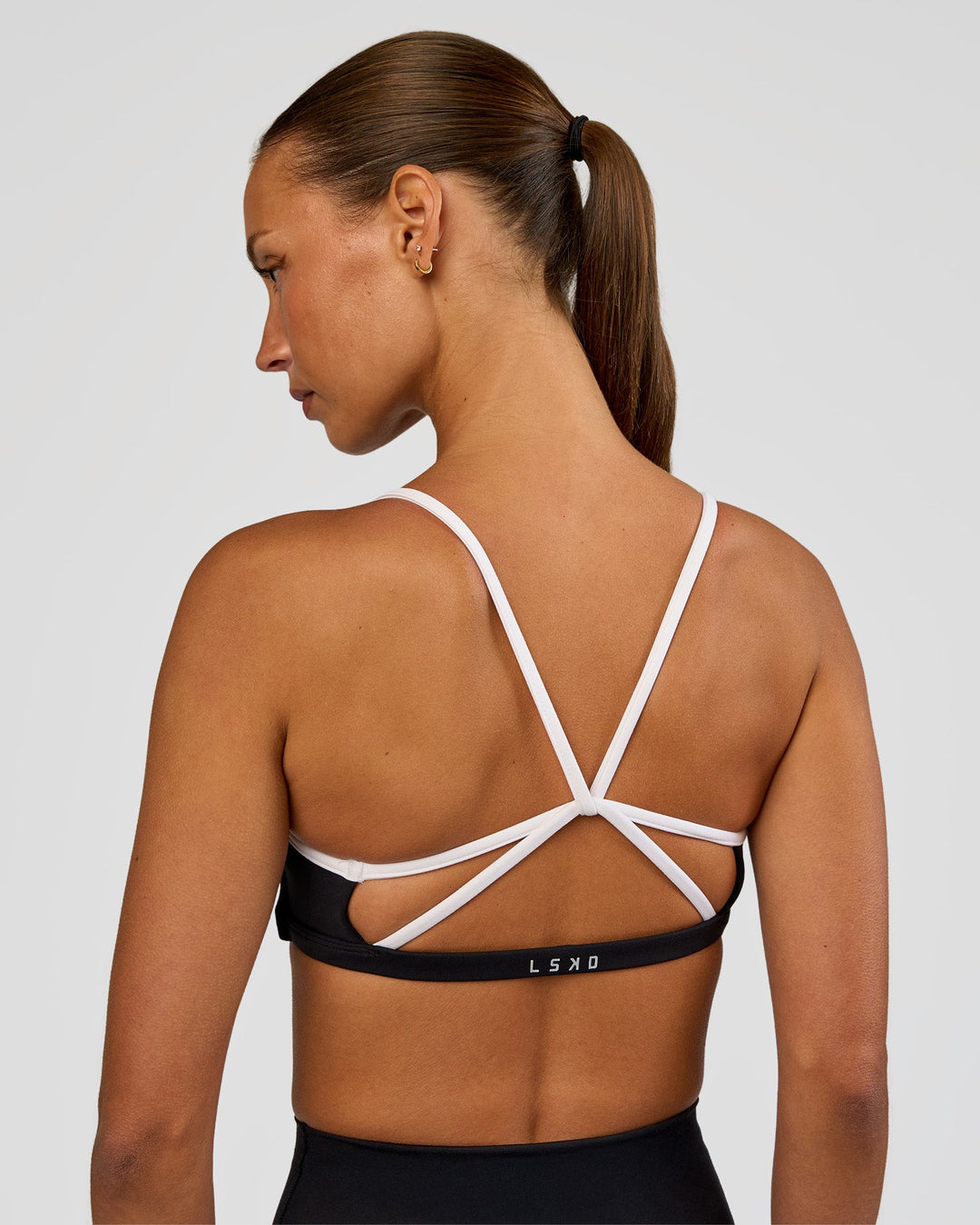 Woman wearing Tempo Sports Bra - Black-White | Model:Brylee | Size:XS