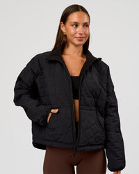 Woman wearing Thrive Reversible Jacket - Black | Model:Brylee | Size:XS
