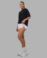 Woman wearing Today's Run FLXCotton Oversized Tee - Black-White | Model:Charlize | Size:XS