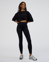 Woman wearing Together We Rise FLXCotton Oversized Tee - Black-Candy Pink | Model:Jordan | Size:XS