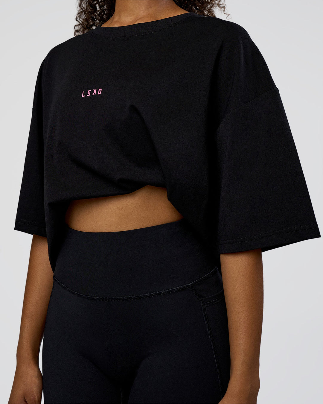 Woman wearing Together We Rise FLXCotton Oversized Tee - Black-Candy Pink | Model:Jordan | Size:XS