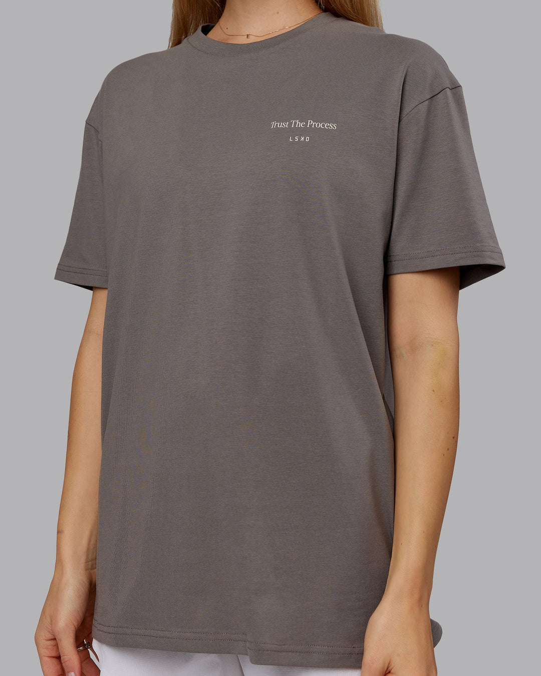 Woman wearing Trust The Process 2.0 FLXCotton Tee Oversize - Storm Front-Shale Beige | Model:Emilie | Size:XS