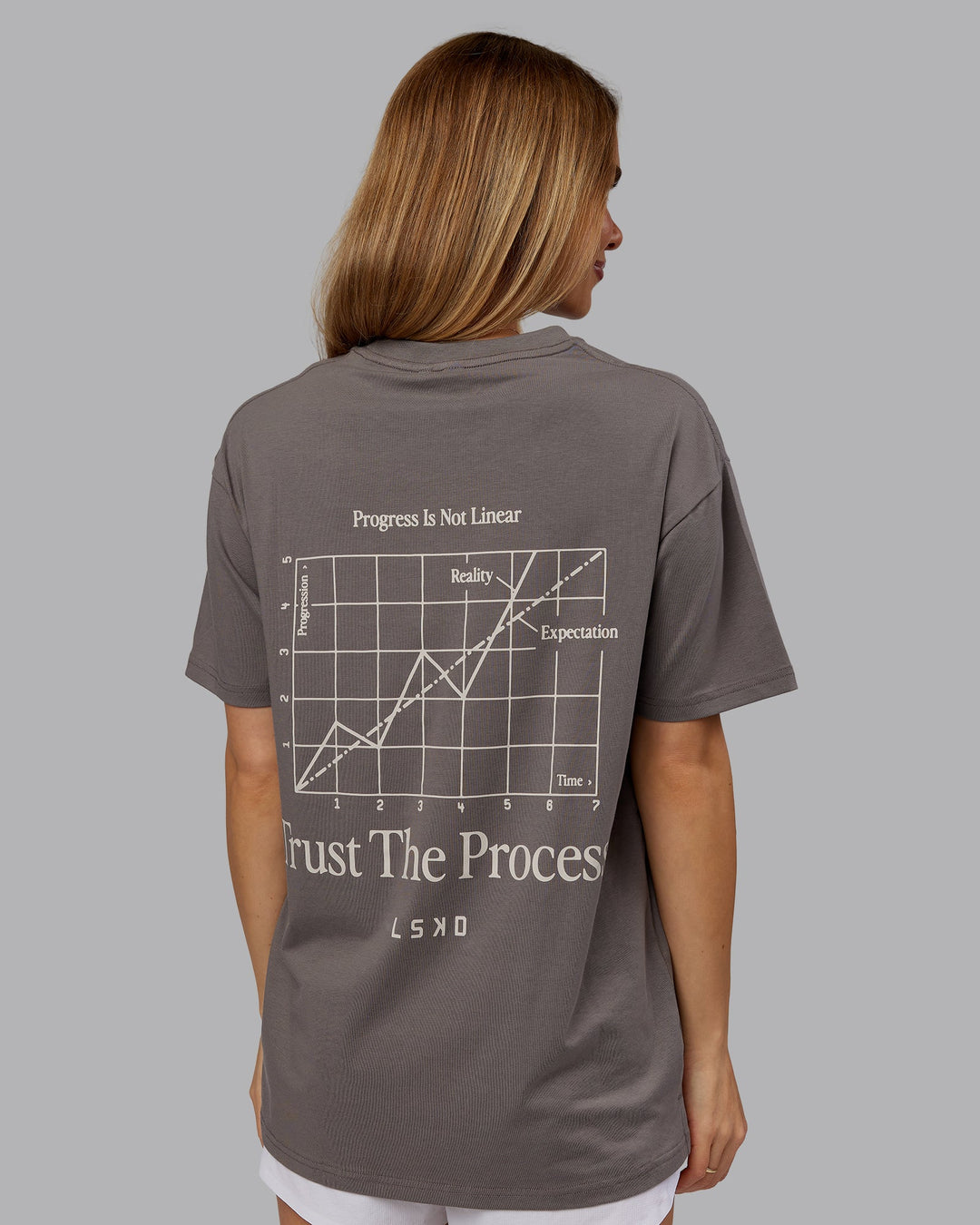 Woman wearing Trust The Process 2.0 FLXCotton Tee Oversize - Storm Front-Shale Beige | Model:Emilie | Size:XS