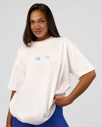 Woman wearing Trust The Process Heavyweight Unisex Oversized Tee - Off White-Electric Indigo | Model:Kirstyn | Size:XS