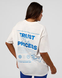 Woman wearing Trust The Process Heavyweight Unisex Oversized Tee - Off White-Electric Indigo | Model:Kirstyn | Size:XS