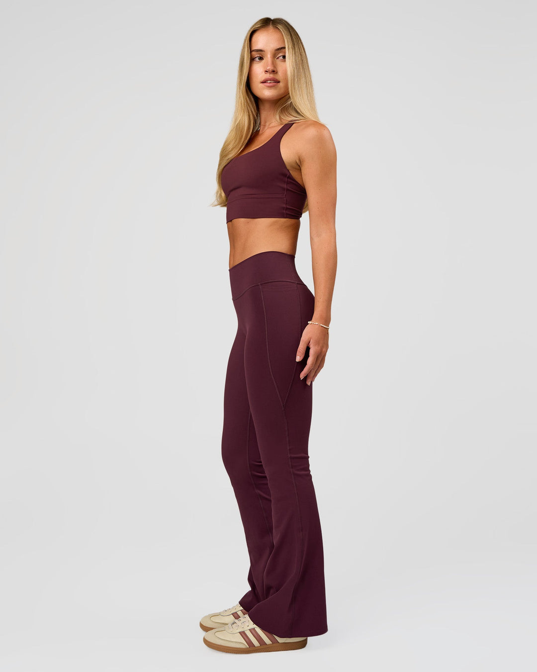 Woman wearing Twist Long Line Sports Bra in Cherry Lacquer | Model:Issy | Size:XS