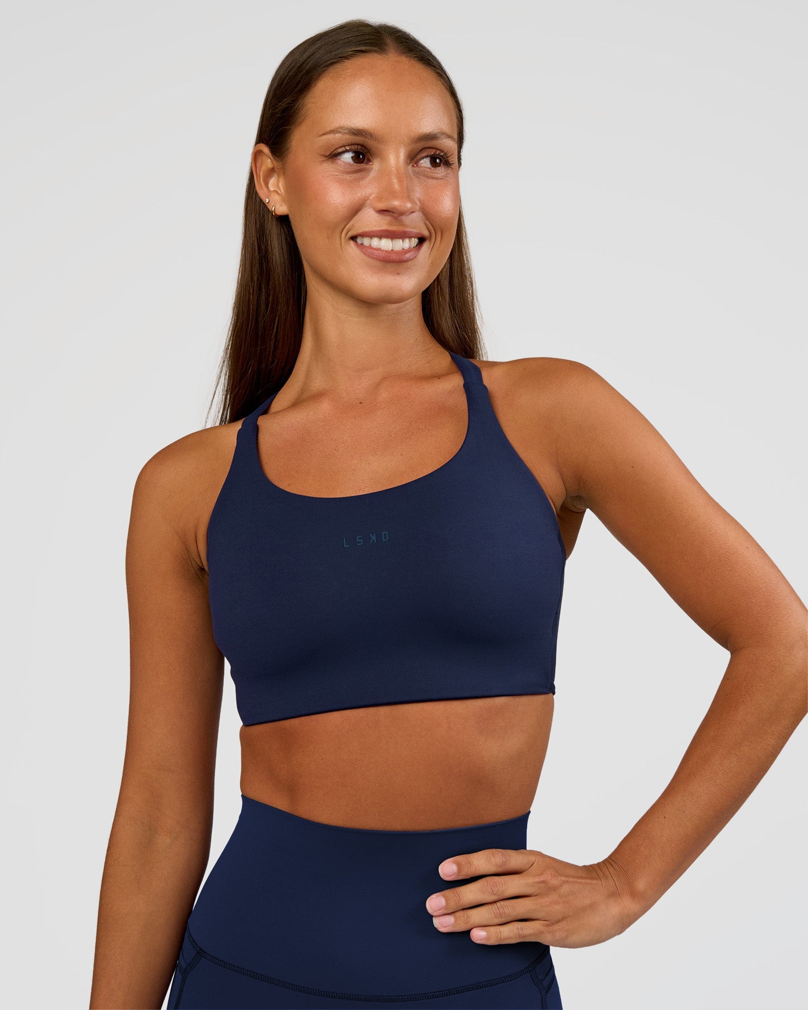 Woman wearing Twist Sports Bra D/DD/E - Future Navy | Model:Brylee | Size:XS