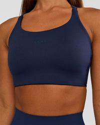 Woman wearing Twist Sports Bra D/DD/E - Future Navy | Model:Brylee | Size:XS