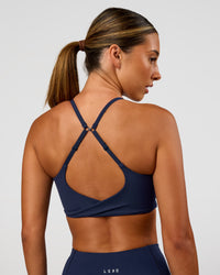 Woman wearing Twist Sports Bra - Future Navy | Model:Charli | Size:XS