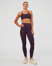 Woman wearing Twist Sports Bra - Midnight Plum | Model:Emelia | Size:XS