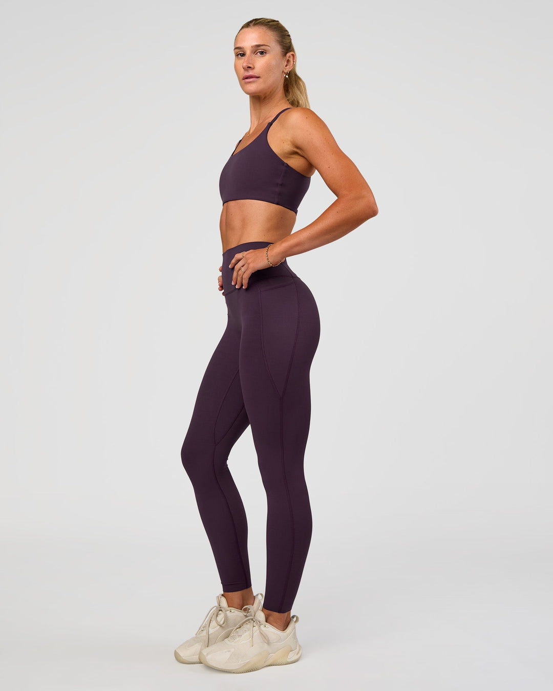 Woman wearing Twist Sports Bra - Midnight Plum | Model:Emelia | Size:XS