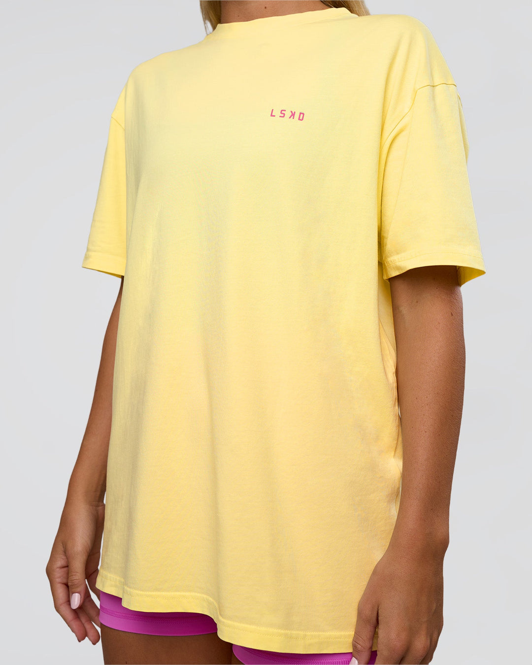 Woman wearing Unfit Club FLXCotton Oversized Tee - Yellow Fizz Washed-Ultra Fuchsia | Model:Amity | Size:XS