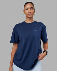 Woman wearing Enjoy the Journey Value Series FLXCotton Tee Oversize - Future Navy-Blue Atoll | Model:Rhiley | Size:XS