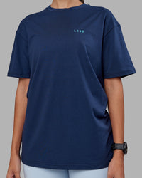 Woman wearing Enjoy the Journey Value Series FLXCotton Tee Oversize - Future Navy-Blue Atoll | Model:Rhiley | Size:XS