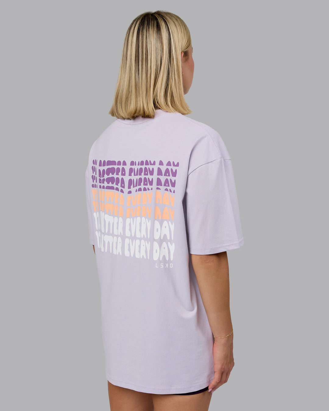Woman wearing On Repeat FLXCotton Oversized Tee - Galactic Lilac-Peach Fuzz | Model:Halle | Size:XS