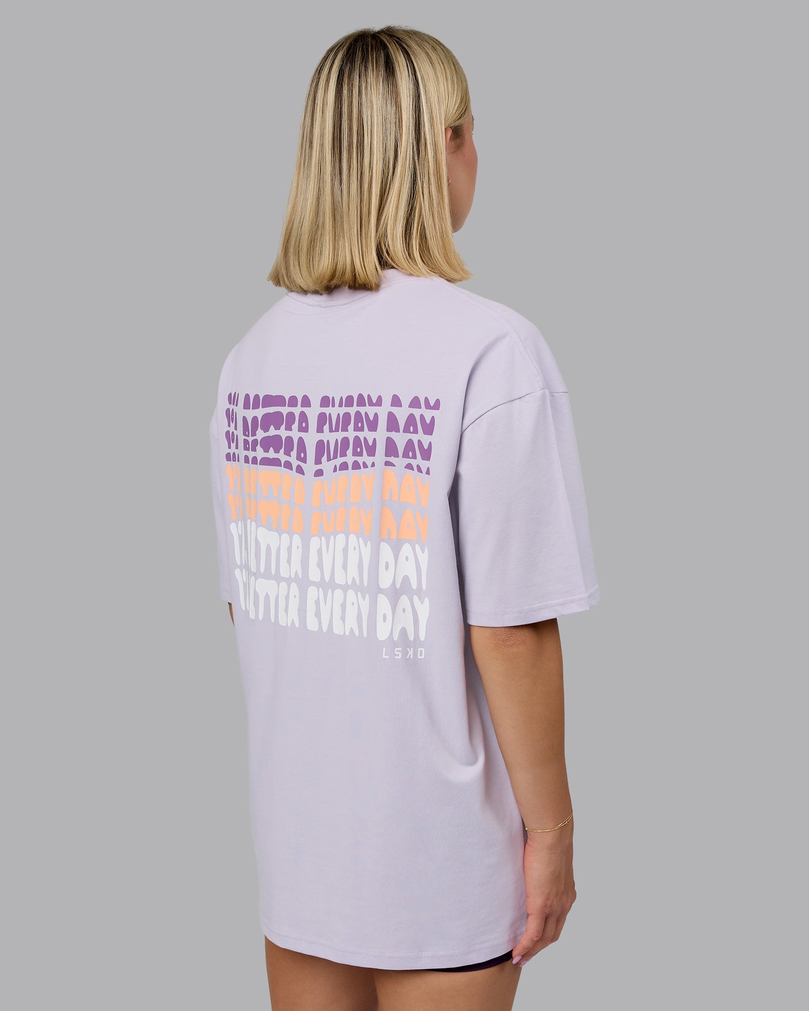 Woman wearing On Repeat FLXCotton Oversized Tee - Galactic Lilac-Peach Fuzz | Model:Halle | Size:XS