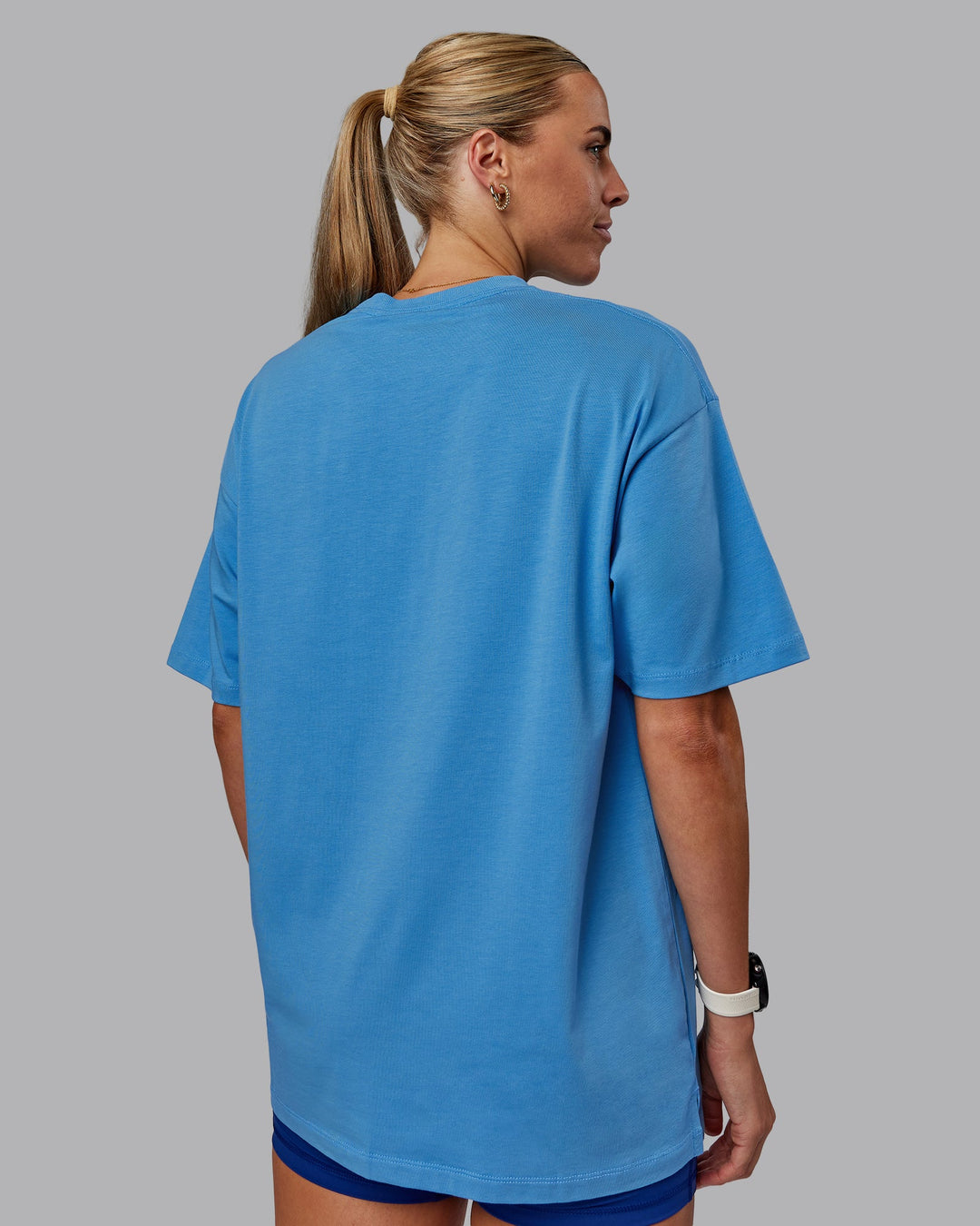 Woman wearing Unisex PimaFLX Tee Oversize in Azure Blue | Size:XS