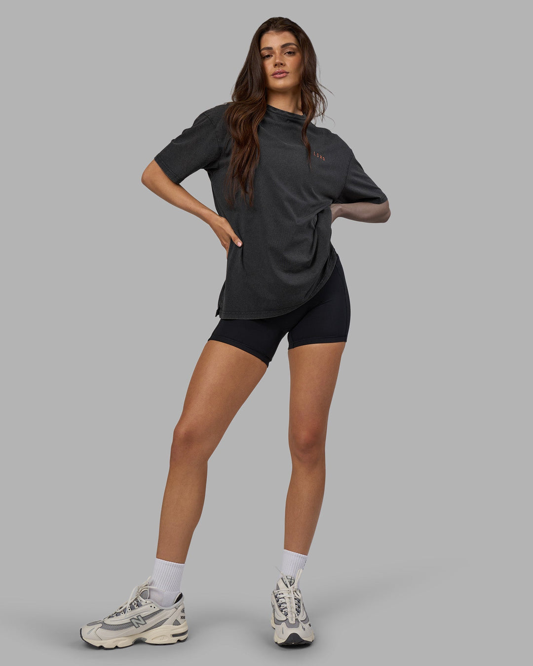 Woman wearing Unisex Strike Through FLXCotton Tee Oversize - Black Washed-Cantaloupe | Model:Phoebe | Size:XS