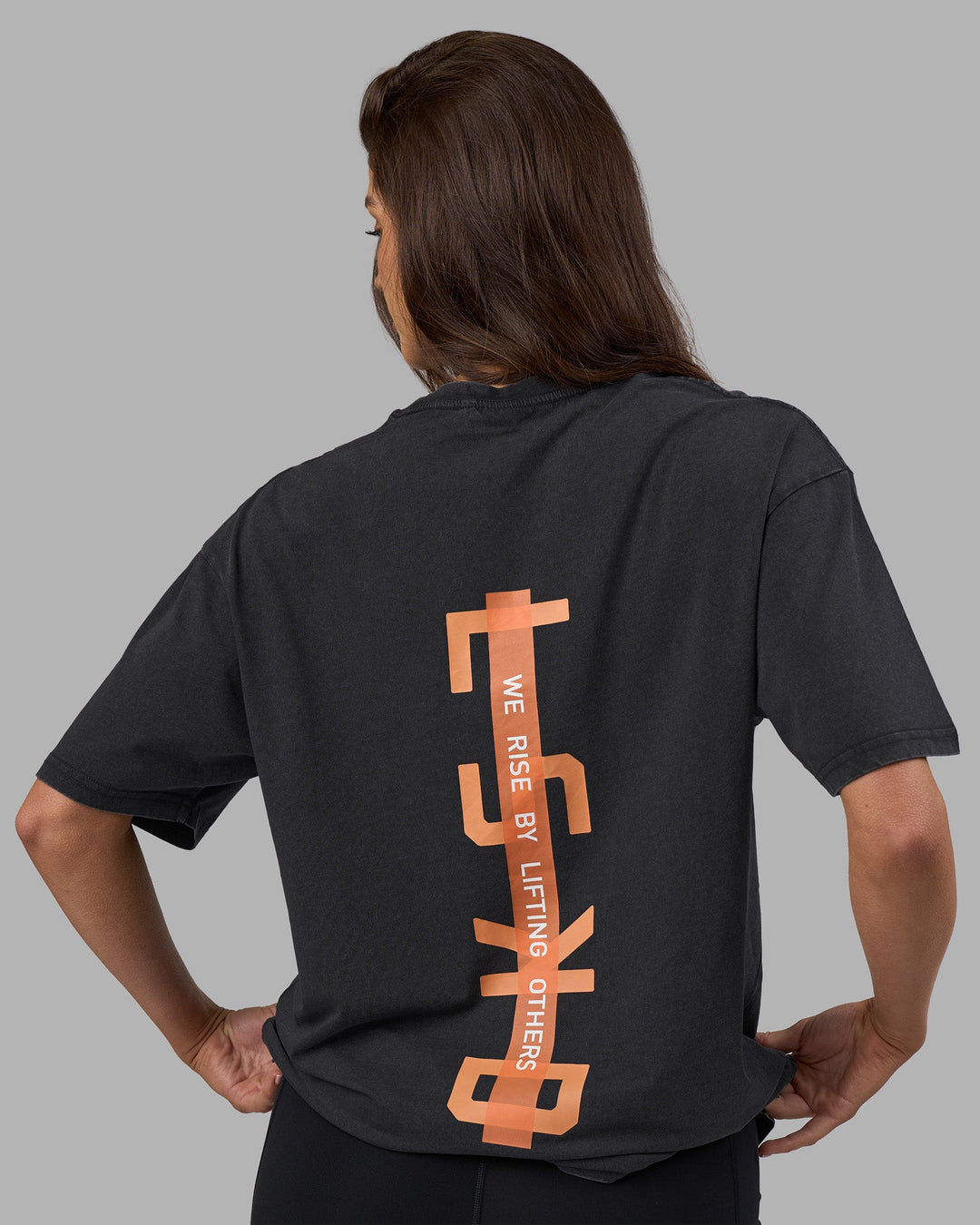Woman wearing Unisex Strike Through FLXCotton Tee Oversize - Black Washed-Cantaloupe | Model:Phoebe | Size:XS