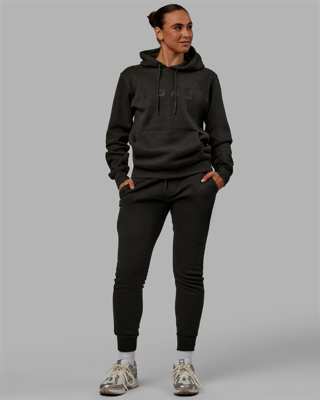 Woman wearing Unisex Structure Hoodie - Pirate Black-Black