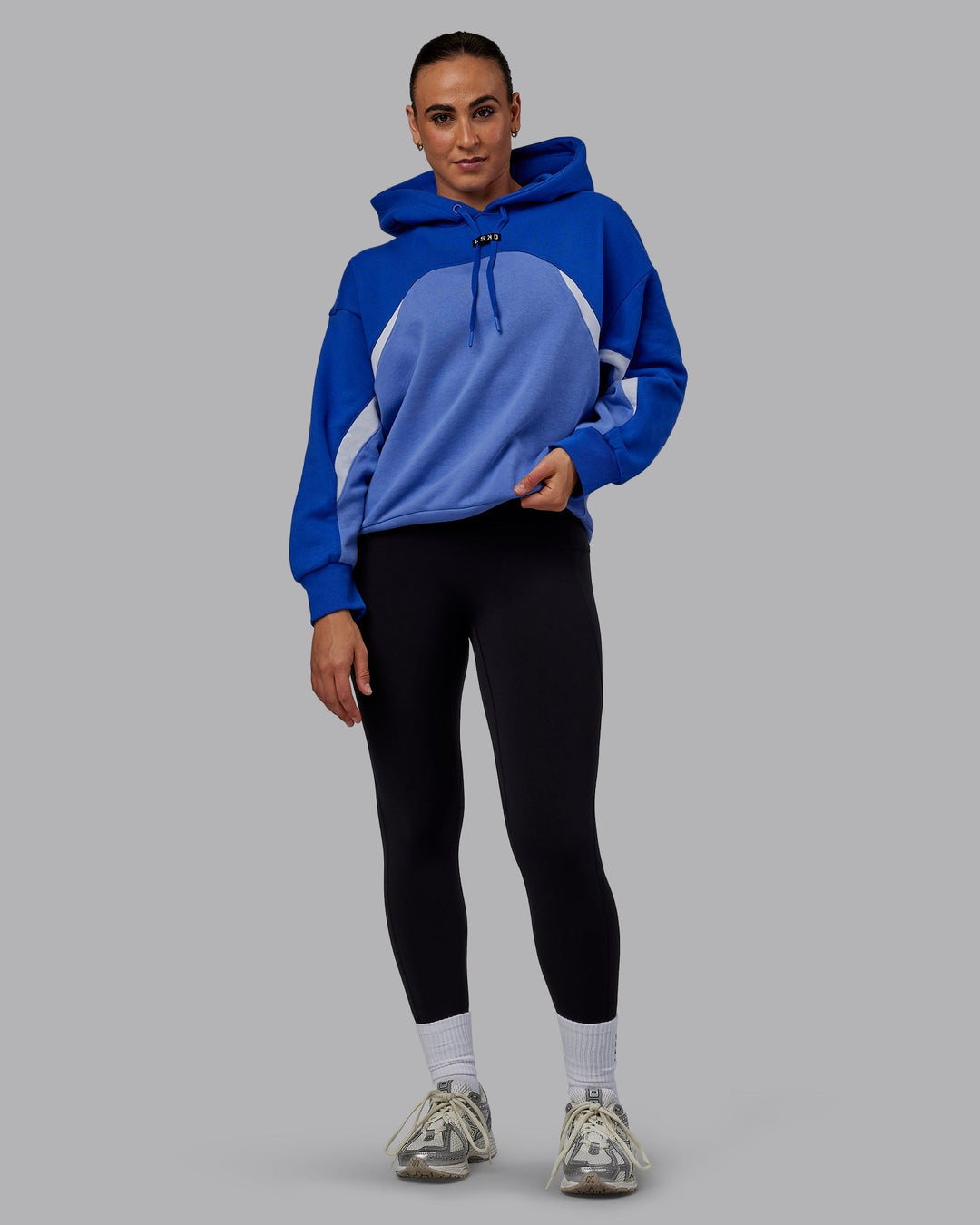 Woman wearing Unisex Y2K Concept Panel Hoodie - Power Cobalt-White