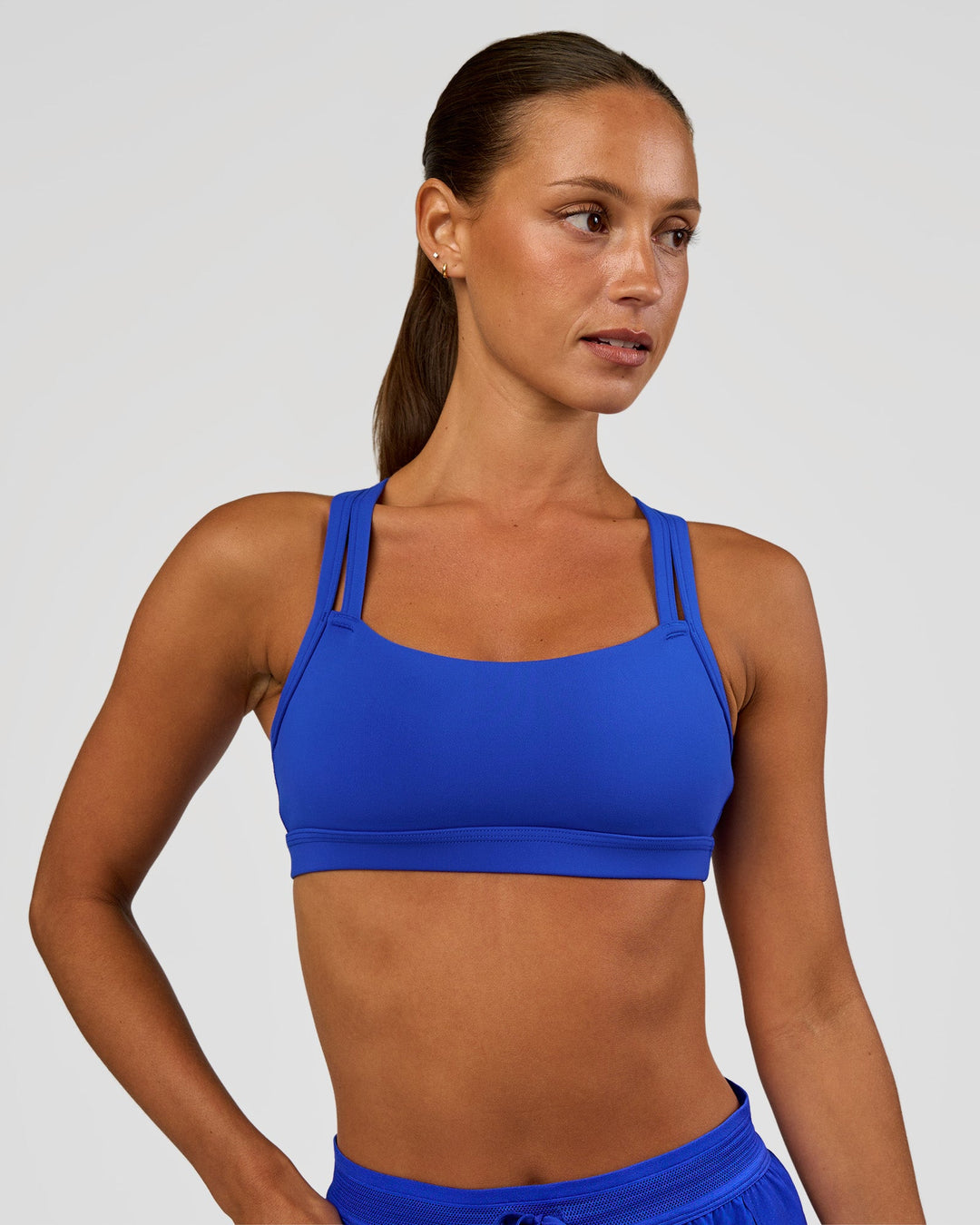 Woman wearing Velocity Sports Bra - Electric Indigo | Model:Brylee | Size:XS