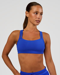Woman wearing Velocity Sports Bra - Electric Indigo | Model:Brylee | Size:XS