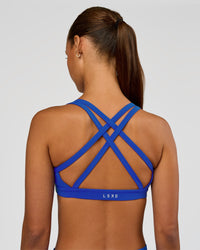 Woman wearing Velocity Sports Bra - Electric Indigo | Model:Brylee | Size:XS