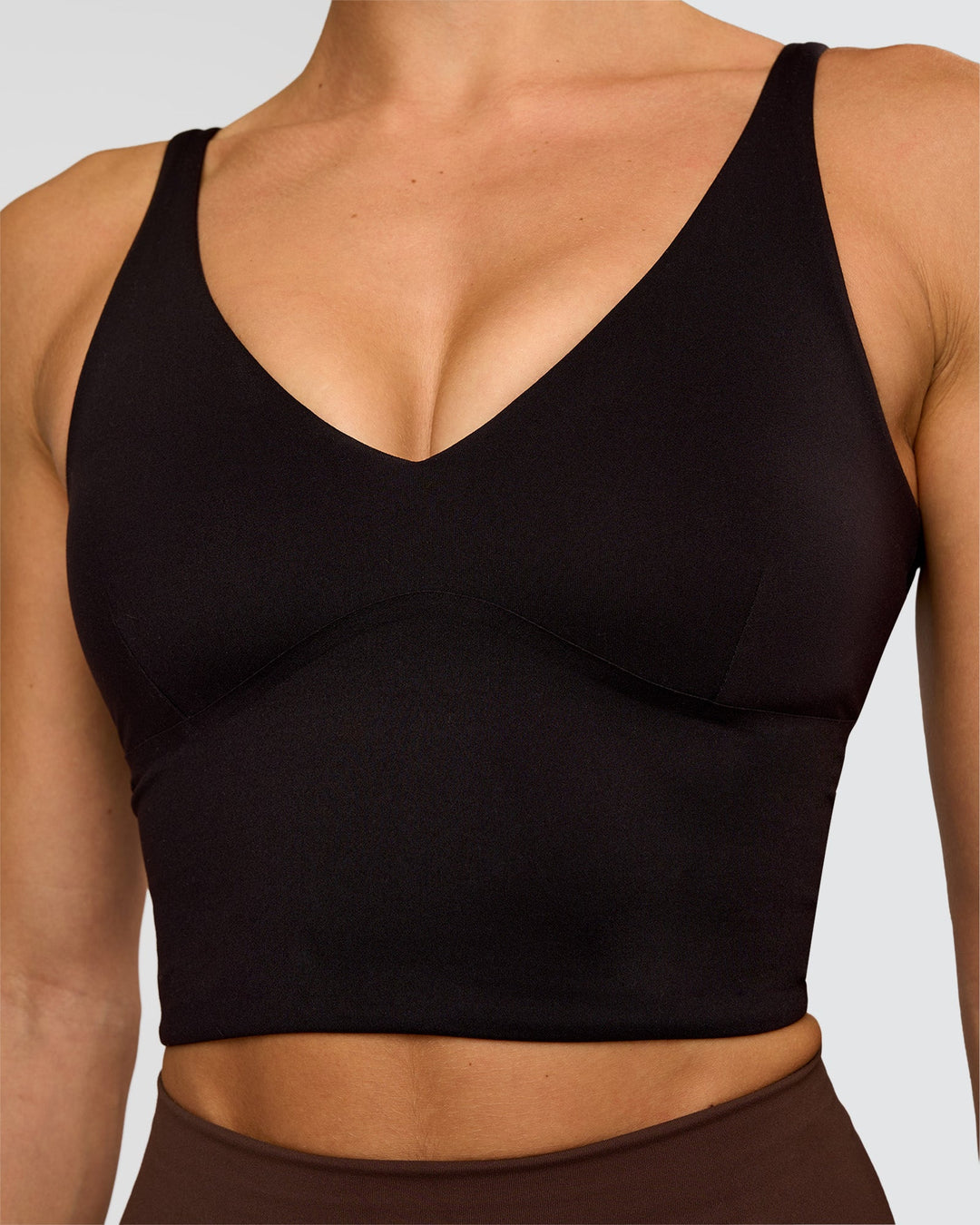 Woman wearing Vitality Long Line Sports Bra - Black | Model:Maja | Size:XS