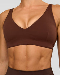 Woman wearing Vitality Sports Bra - Hot Chocolate | Model:Maja | Size:XS