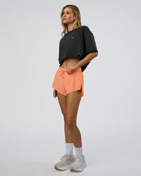 Woman wearing We Love This  FLXCotton Oversized Tee - Black Washed-White | Model:Leilani | Size:XS