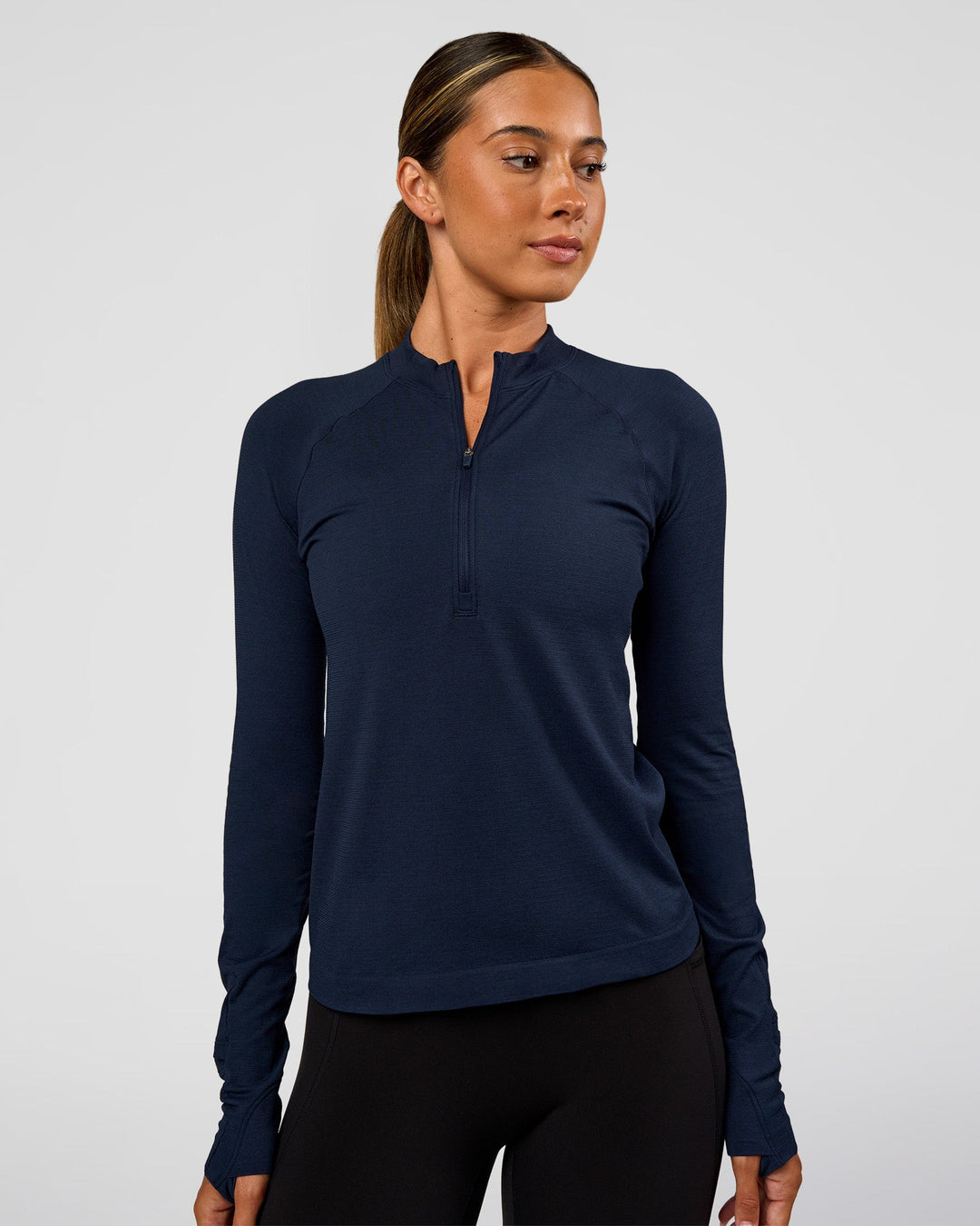 Woman wearing AeroFLX+ Long Sleeve Half Zip - Future Navy/Future Navy | Model:Charli | Size:XS - view 1