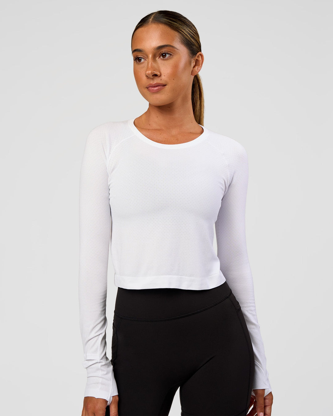 Woman wearing AeroFLX+ Seamless Long Sleeve Skimmer Tee - White/White | Model:Charli | Size:XS - view 4