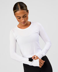 Woman wearing AeroFLX+ Seamless Long Sleeve Skimmer Tee - White/White | Model:Charli | Size:XS | Thumbnail Index: 0