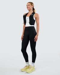 Woman wearing Pace Running Vest - Black-Reflective | Model:Evie | Size:XS/S