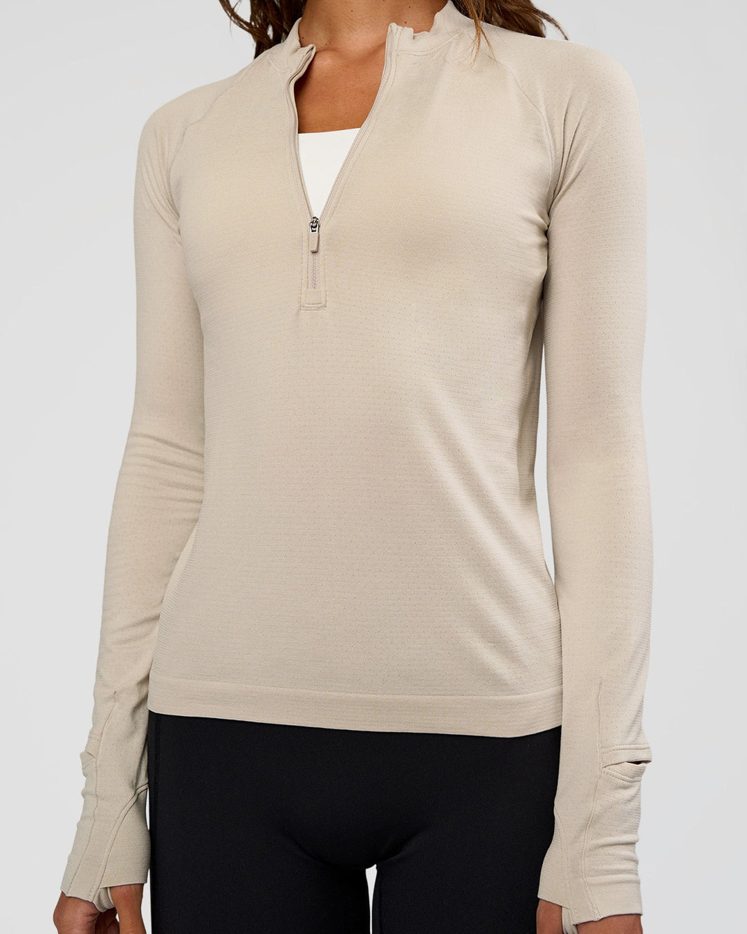 Woman wearing AeroFLX+ Long Sleeve Half Zip - Shale Beige/Shale Beige | Model:Dakota | Size:XS - view 4