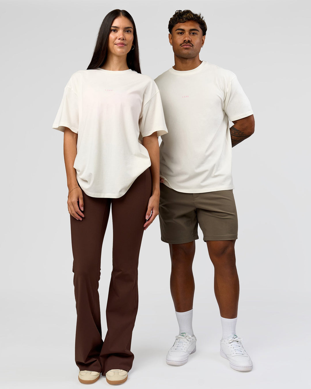Duo wearing Built On Values FLXCotton Oversized Tee - Off White-Pink Rose | Model:Xav | Size:L | Model:Rhiley | Size:XS
