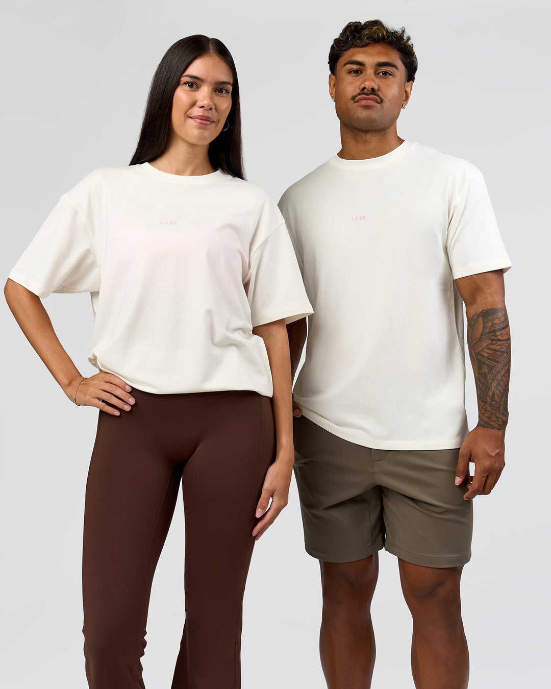 Duo wearing Built On Values FLXCotton Oversized Tee - Off White-Pink Rose | Model:Xav | Size:L | Model:Rhiley | Size:XS