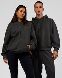 Duo wearing Base Oversized DC Hoodie - Onyx | Model:Albert | Size:M | Model:Bianca | Size:XS | Thumbnail Index: 0
