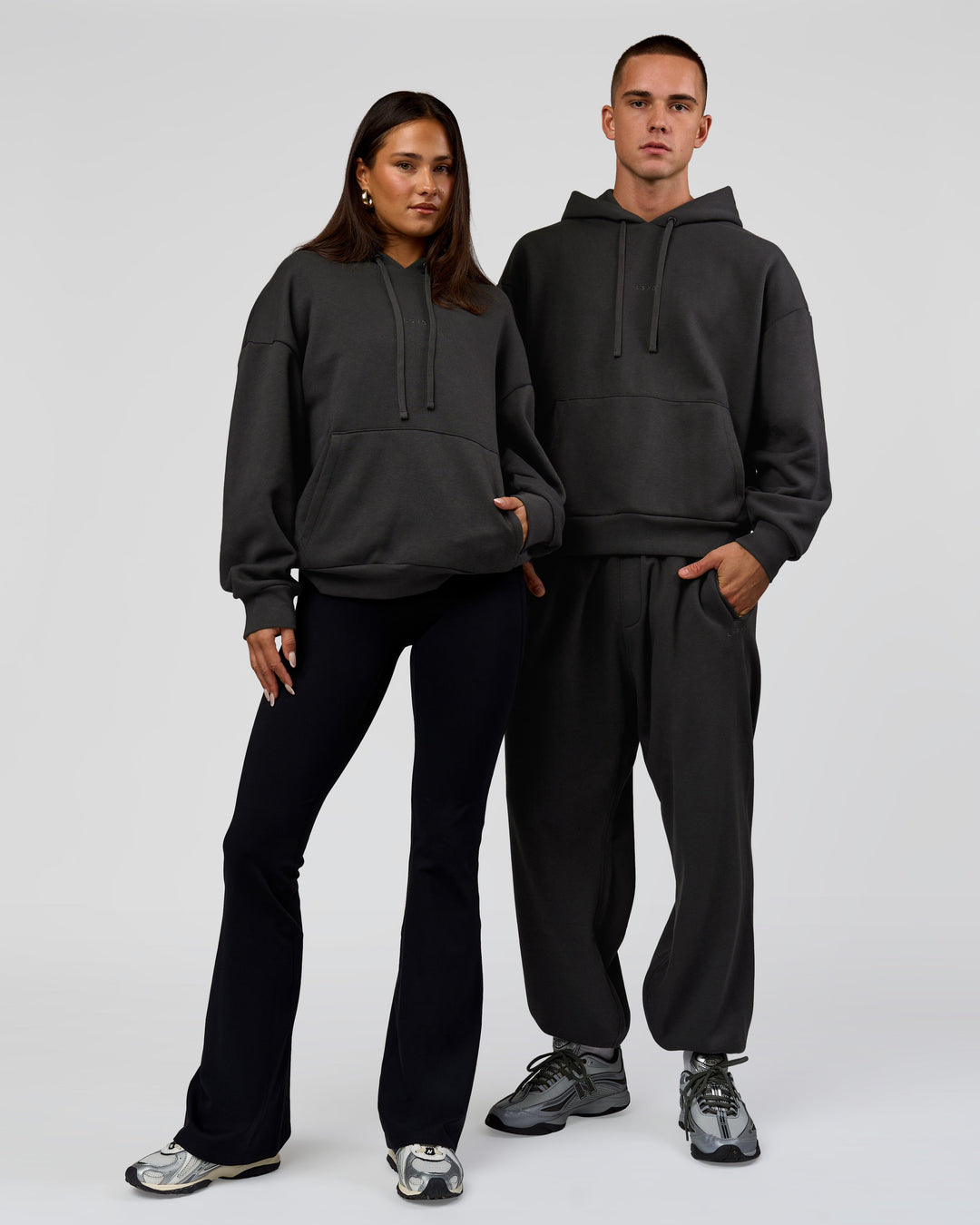 Duo wearing Base Oversized DC Hoodie - Onyx | Model:Albert | Size:M | Model:Bianca | Size:XS - view 2