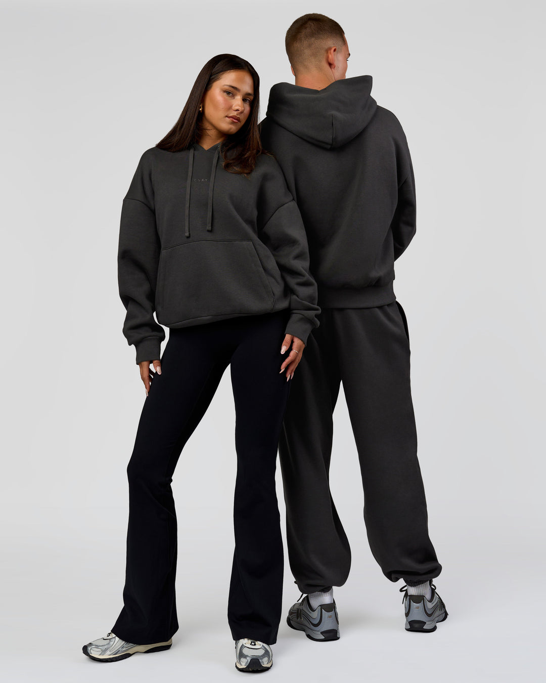 Duo wearing Base Oversized DC Hoodie - Onyx | Model:Albert | Size:M | Model:Bianca | Size:XS - view 3