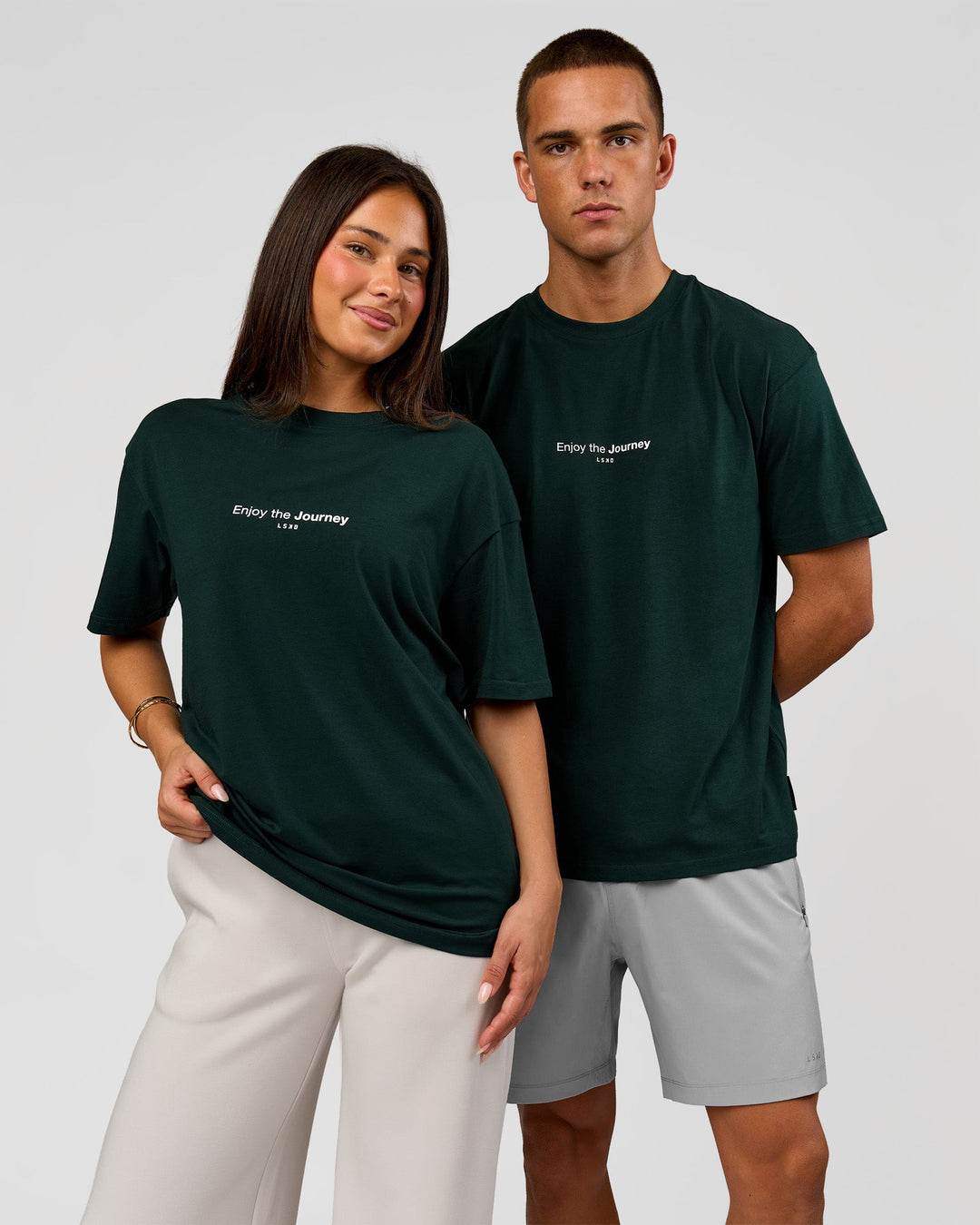 Duo wearing VS1 Enjoy The Journey FLXCotton Oversize Tee - Midnight Green | Model:Albert | Size:M | Model:Bianca | Size:XS - view 1