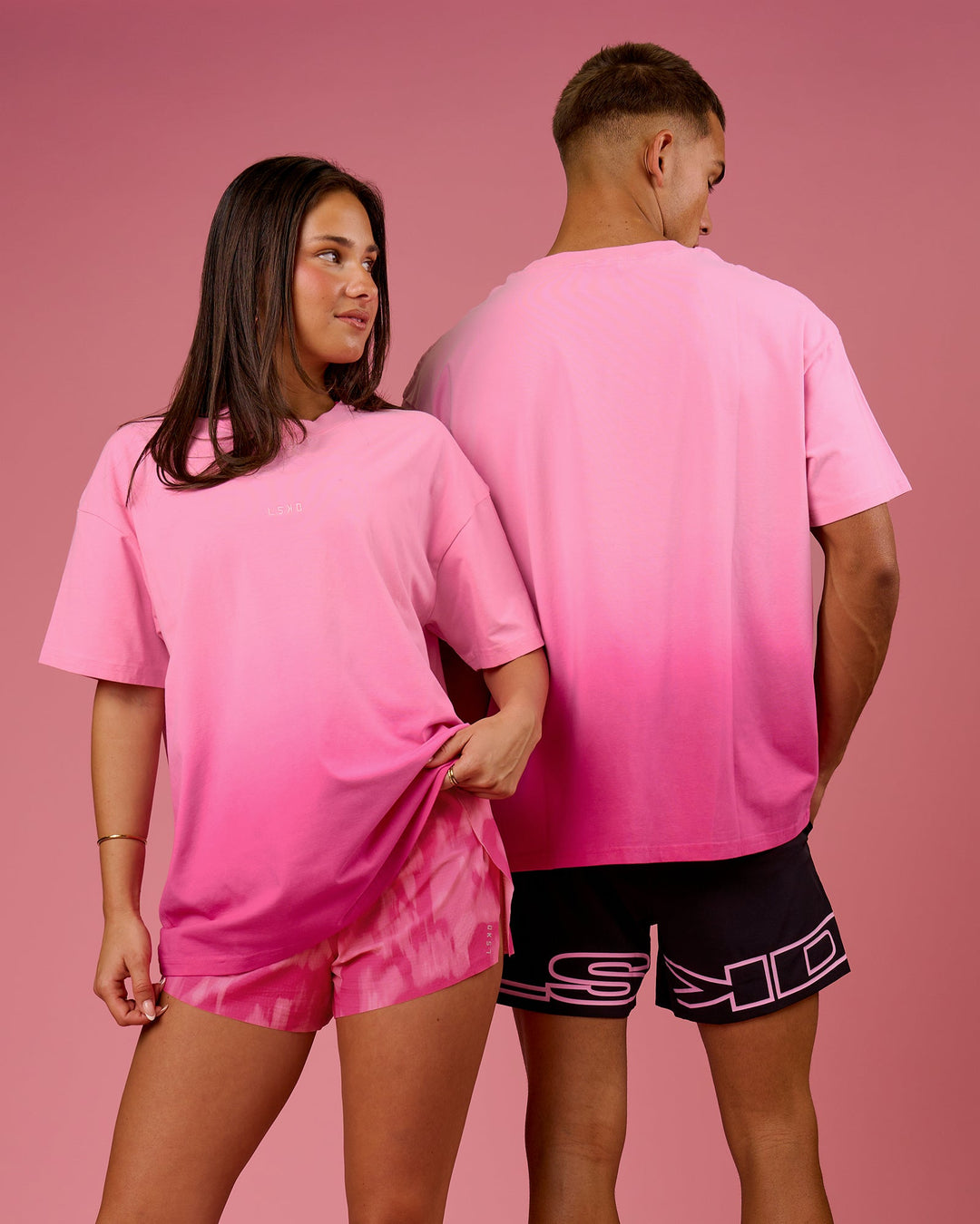 Duo wearing BCAM Ombre Heavyweight FLXCotton Oversized Tee  - Pink Rose-Ultra Pink | Model:Bianca | Size:S | Model:Albert | Size:M - view 13