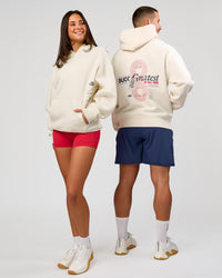 Duo wearing Greatest of All Time Heavyweight Oversized Hoodie - Off White | Model:Bianca | Size:XS | Model:Jaiden | Size:L | Thumbnail Index: 1