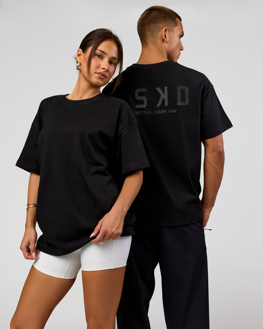 Duo wearing Tonal Legacy Heavyweight Oversized Tee - Black-Black | Model:Bianca | Size:XS | Model:Albert | Size:M - view 1