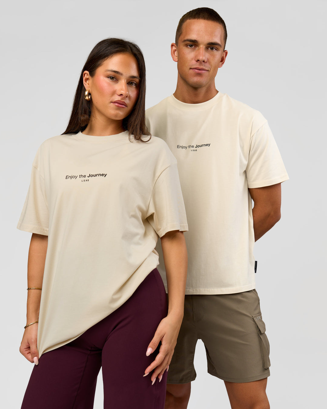 Duo wearing VS1 Enjoy The Journey FLXCotton Oversize Tee - Vanilla Bean | Model:Bianca | Size:XS | Model:Albert | Size:M - view 6
