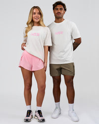 Duo wearing SoCal 26 FLXCotton Oversize Tee  - Off White-Pink Rose | Model:Issy | Size:XS | Model:Xav | Size:L | Thumbnail Index: 3