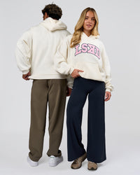 Duo wearing Varsity Boxy Hoodie - Off White-Pink Rose | Model:Issy | Size:XS | Model:Xav | Size:L | Thumbnail Index: 1