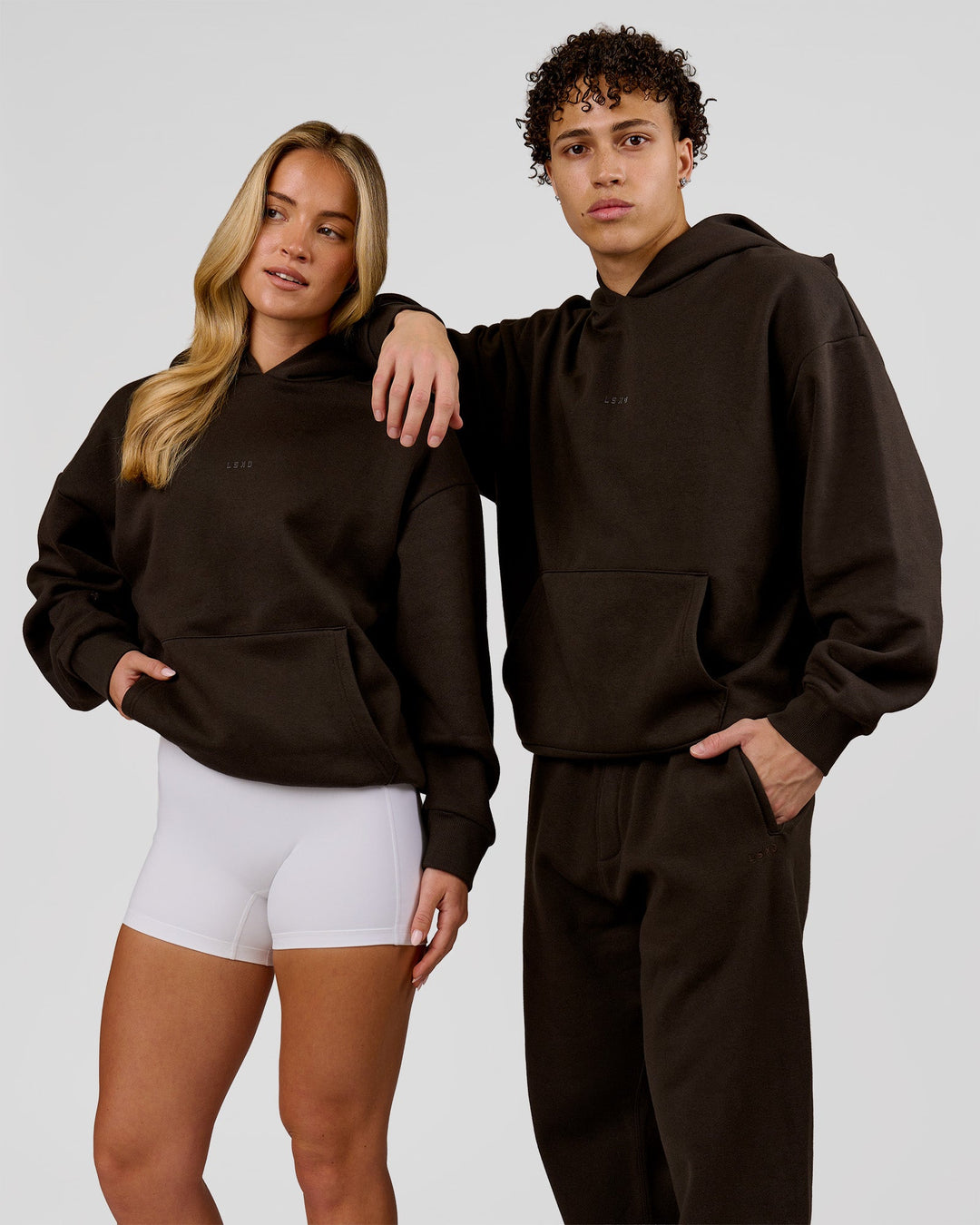 Duo wearing Base Oversized Hoodie - Ground Coffee | Model:Issy | Size:XS | Model:Leandro | Size:M - view 3